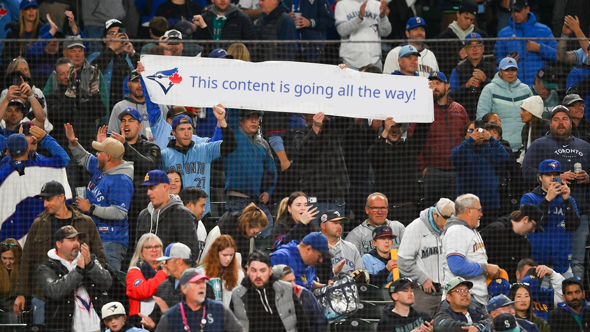 A crowd of Blue Jays fans, with a sign that says, This content is going all the way!