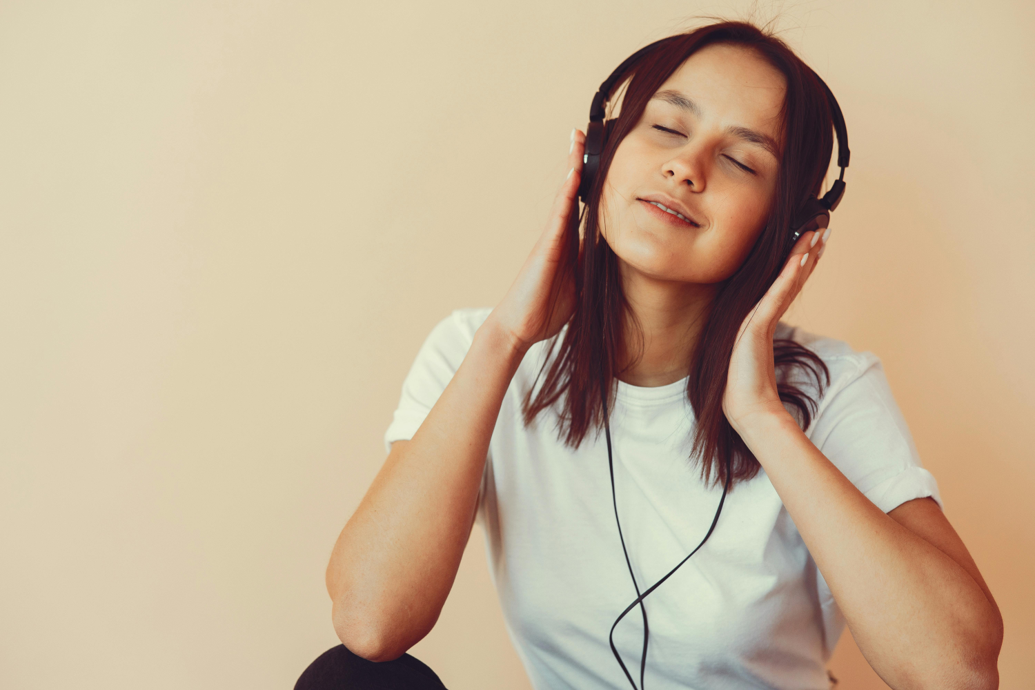 A woman listening to headphones.